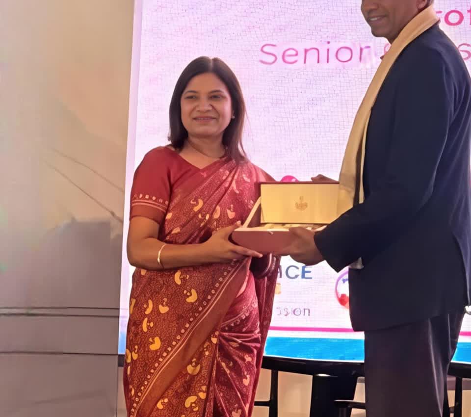 Dr. Ammbulkar being felicitated on stage at Integrated Cancer Update 2026